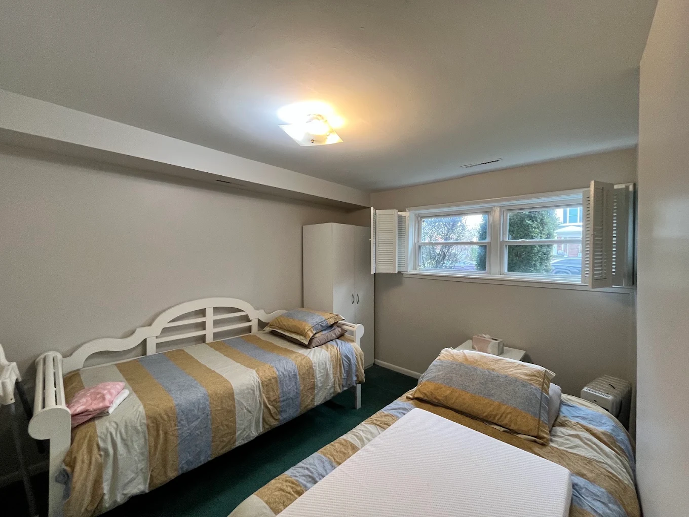 Basement bedroom repainted a clean neutral with bright white ceiling